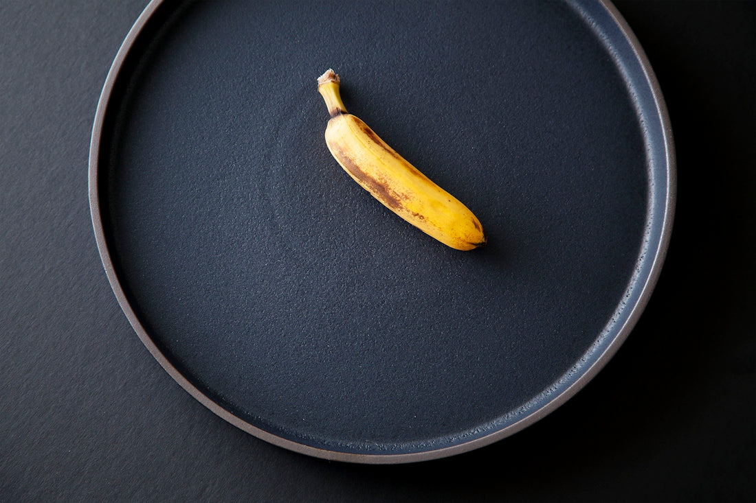 yellow banana peel on black round plate