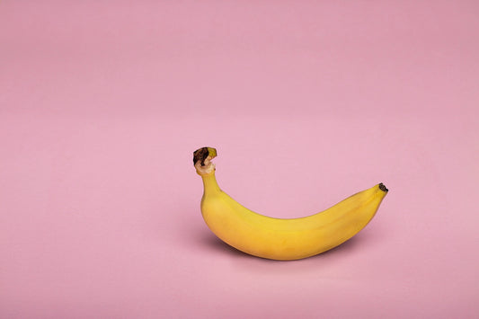 yellow banana fruit on white surface