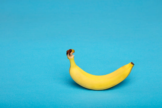 yellow banana fruit on blue surface