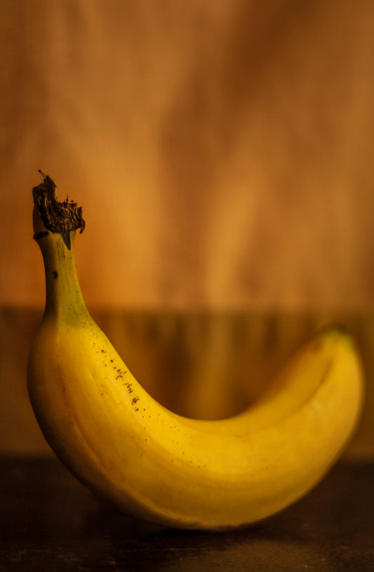 A ripe banana sitting on top of a wooden table